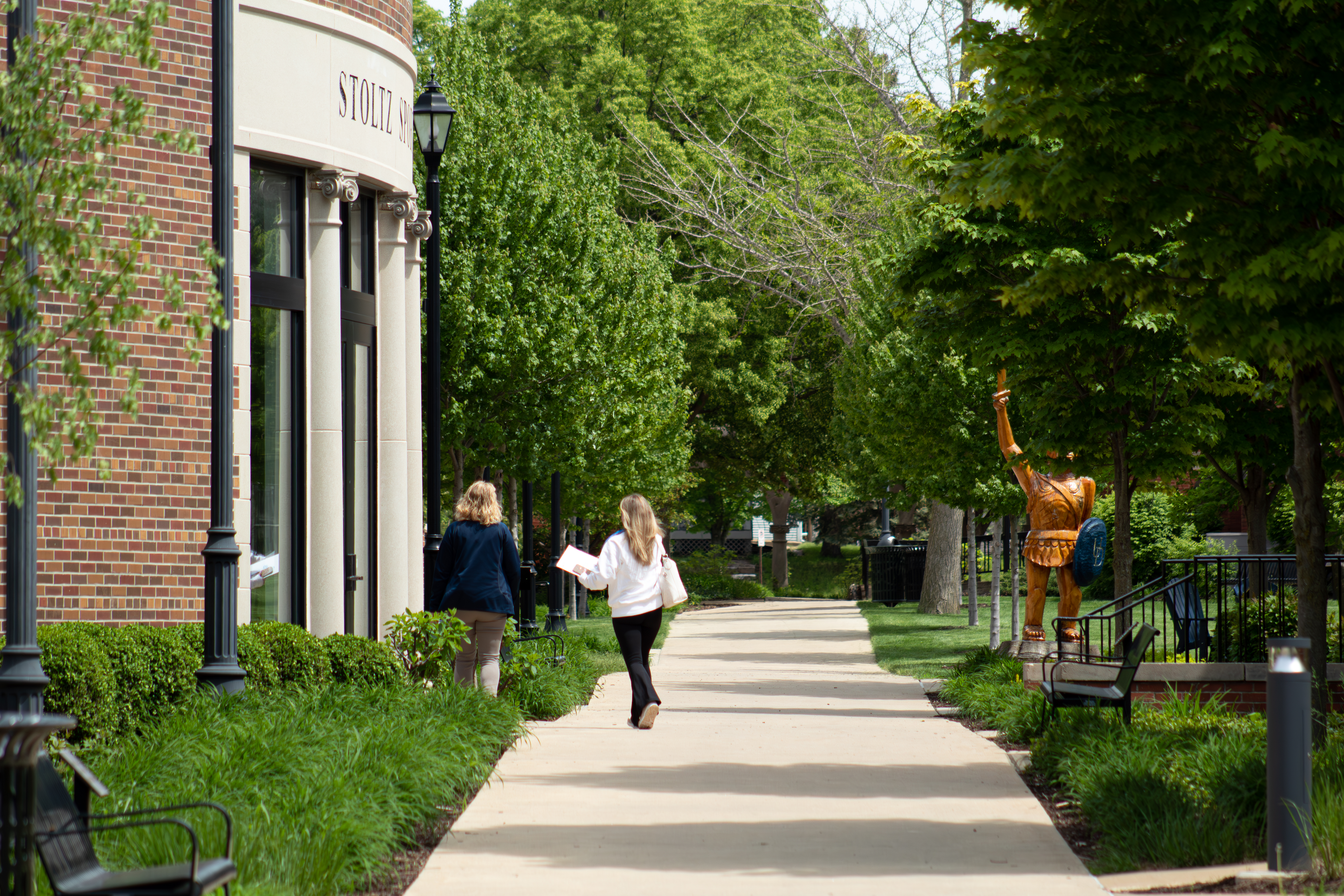 Two people walking near Stoltz Sports Center at UD